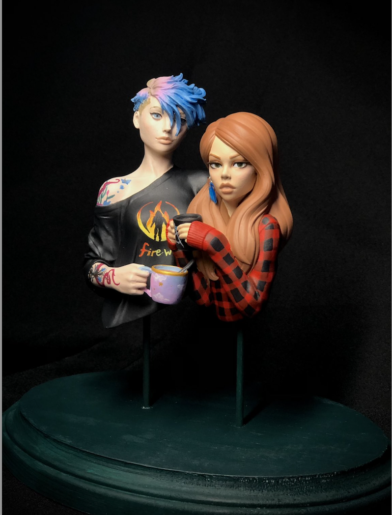 Art models displayed on a dark teal pedestal, one female presenting art model with blue and pink short hair is wearing a black shirt with 'firewalk' written in orange and yellow text. It's holding a blue and pink sky mug. On the right, another female presetning art model with strawberry blonde hair wearing a blacka dn red check shirt and holding a black mug and an anarchy symbol on it.